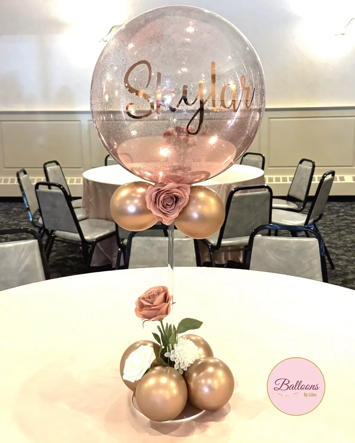 Rose gold balloon centerpiece idea for guest tables and lounge areas