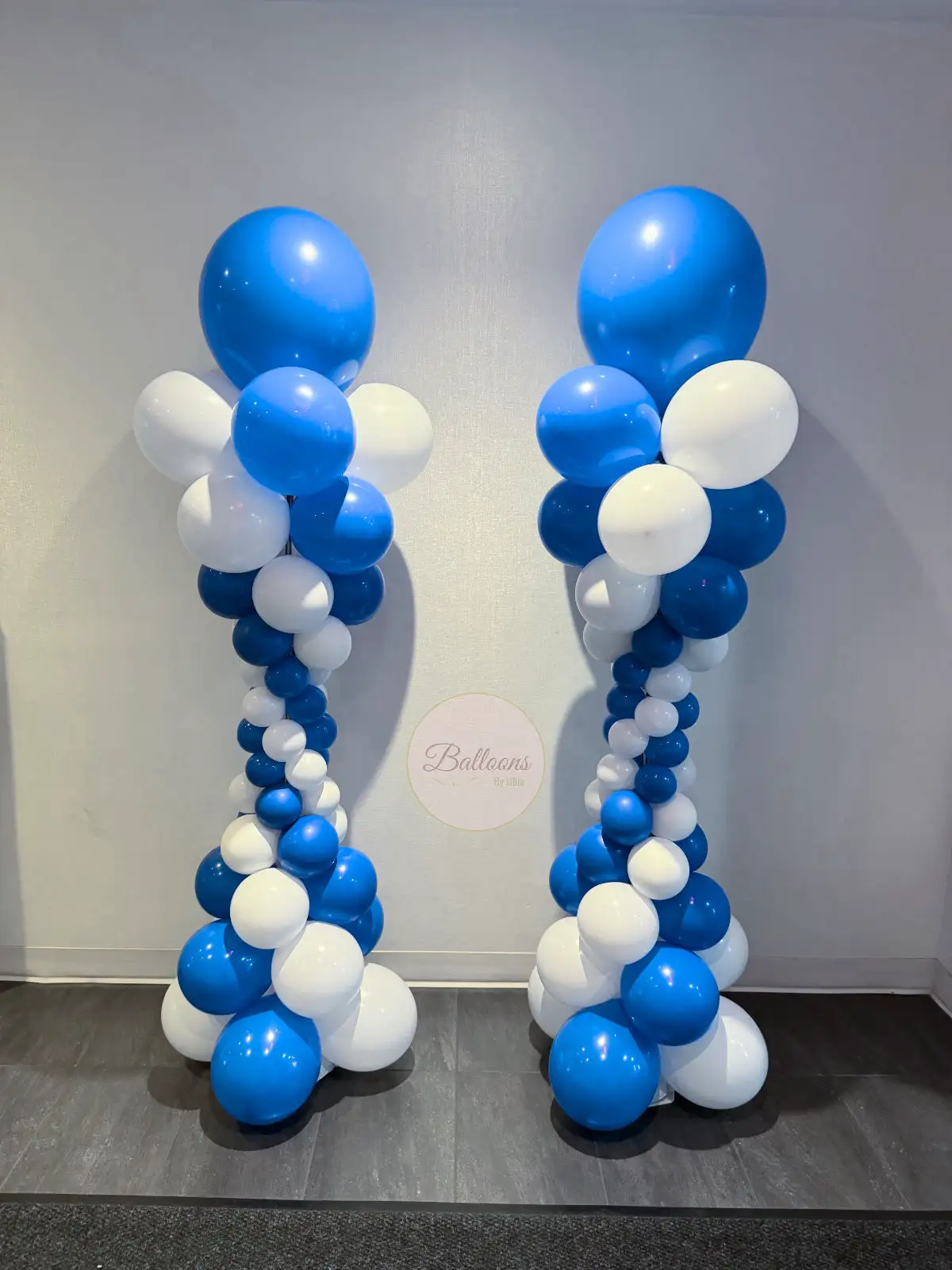 White and blue corporate balloon columns for office or school events